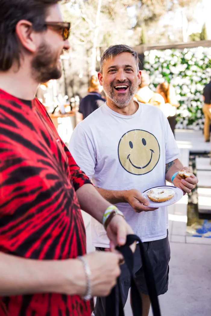Guest in a floral shirt at the Hall of Flowers Bagel Bash in Ventura